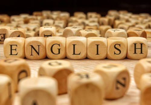 Word English spelled out with wooden blocks