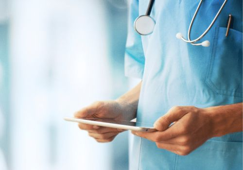 Doctor holding ipad in hospital