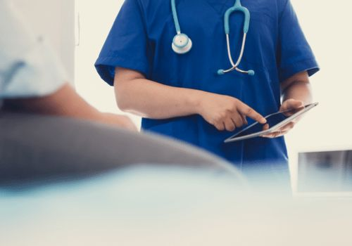 Doctor holding ipad in hospital