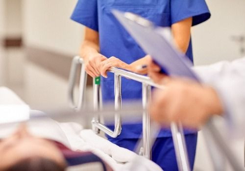 Doctors looking over patient