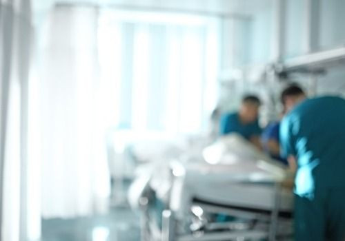 Intensive care ward with two doctors around a bed