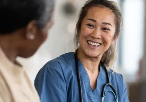 Doctor smiling at elderly patient