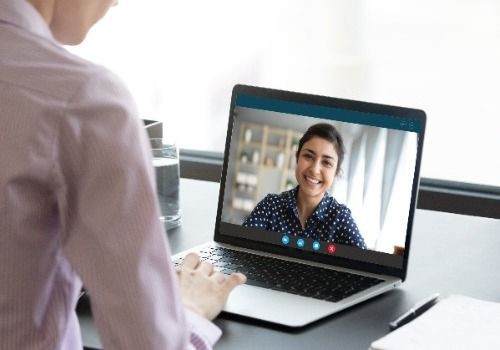 Man talking to woman on video call on laptop